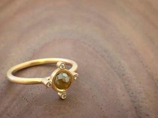 One of a kind 18k yellow gold ring with a natural colored rose cut diamond and colorless round diamonds.