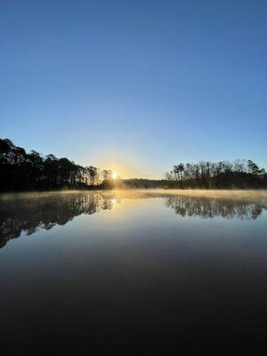 Sunrise on lake with fog