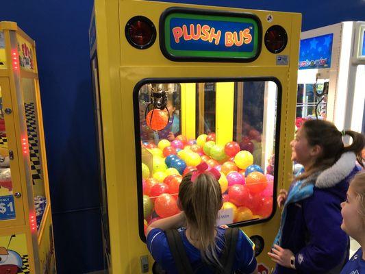 Adrianna winning a ball on the claw machine!