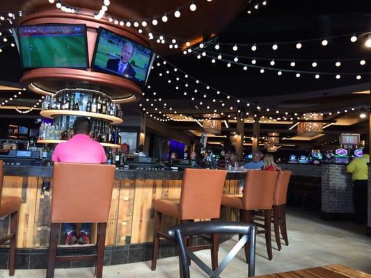 Bar seating and tables surrounding the bar.