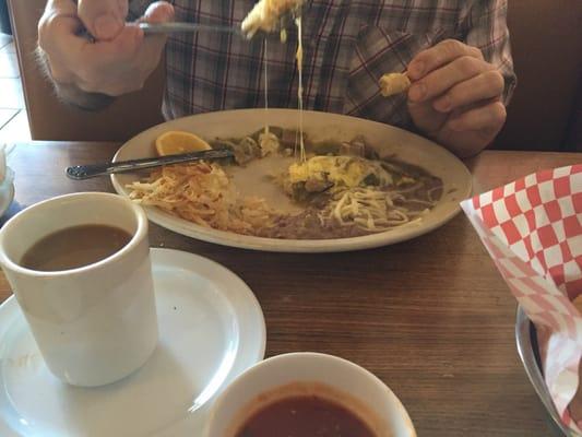 Hubby is tearing up his Chile Verde Omelette. Chile Verde in a omelet.