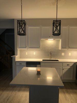 Quartz countertops, subway tile install, and new sink.