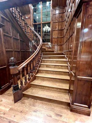 Grand staircase with chandelier in Holiday Estate.