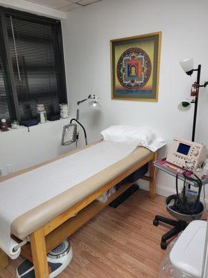 Treatment room depicting the use of medical technology for the treatment of physical and painful conditions.