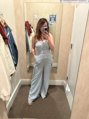 Light wash jean jumpsuit with cute pockets  for reference, this is a size M! I'm 5'2" and usually a size XS/S