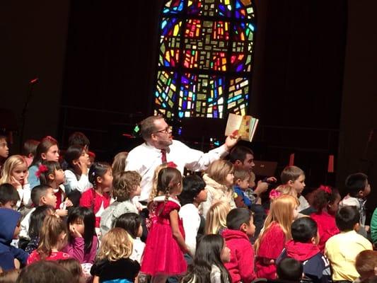 Pastor Travis Marsh reads to a flood of Canyon Creek Kids during the 2015 Christmas Eve Family Service.