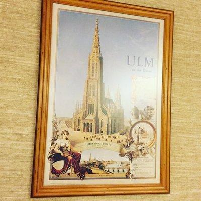 This is a travel poster (ca. 1890?) for the city of Ulm, featuring the spire of its renowned church, claiming to be "tallest in the world".