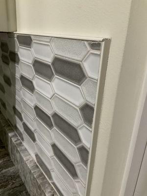 Corners doesn't align 
 Broken tile.
 Top protruding from wall