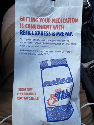 © 2021 Erik D. Phillips Prescription bag with an advertisement for the HEB pharmacy Refill Xpress service.