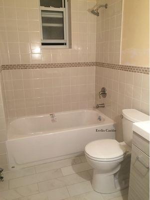 Bathroom renovation; installed new bathtub, toilet, sink w/ vanity, and new ceramic tile (on walls and floor)