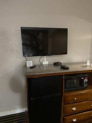 Tv and stand with microwave and fridge