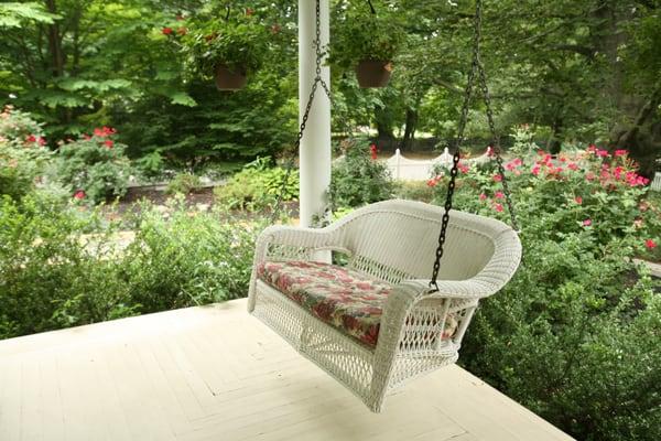 Wicker swing on wraparound porch