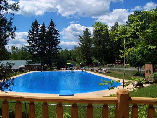 View of pool from treehouse cabin deck.