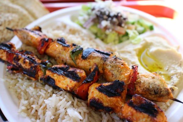 Chicken Tawook kabobs with hummus and Greek salad (olives and feta cheese)