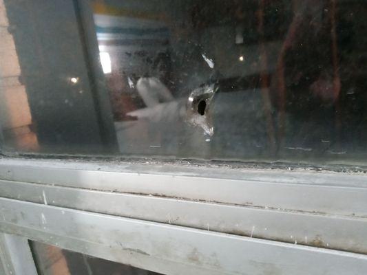 Bullet hole and reflection of room in the glass