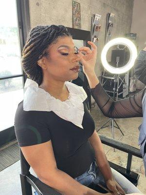 Makeup Artist Ledora D Carasca working on a client