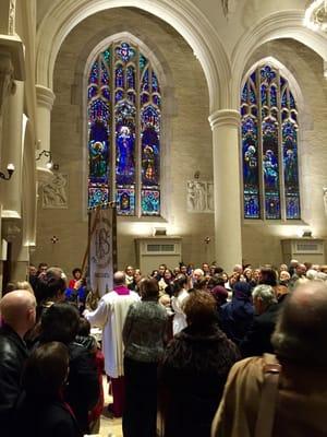 200TH ANNIVERSARY of the vigil to Our Lady of Prompt Succor, processing before the vibrant stained glass windows.