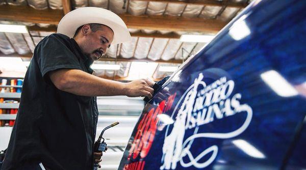 Mr. Alvaro getting into the cowboy role, almost there! #wraps #vehiclewraps #carodeo