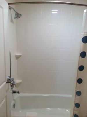 Large curved rod shower with deluxe heads.