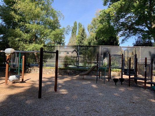 Playground with tennis court in the back