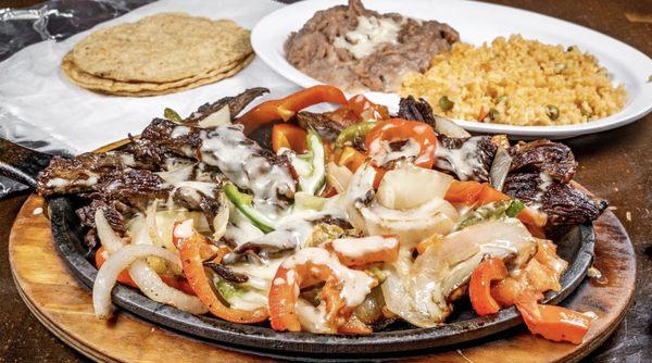 Alambre, tenderloin steak mixed with bacon, bell-pepper, onions topped with fresh mozzarella. served with rice, beans, and tortillas.