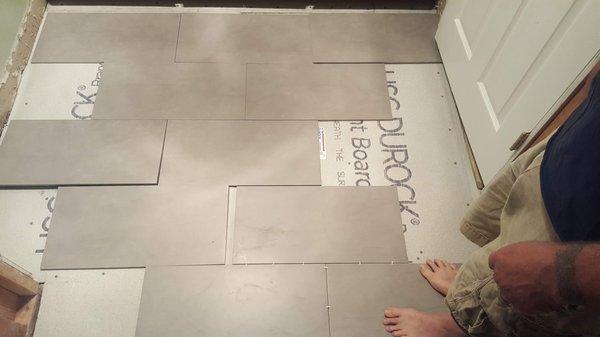 Laying new tile and also new shower with added niches!