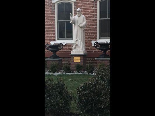 Closer view of statue of St Charbel, sculpted by artisan in Lebanon from native stone. Embedded within the statue is a relic of the saint.