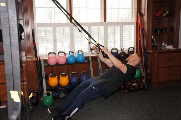 TRX Rows for improved posture by engaging posterior torso muscles to build a stronger back.