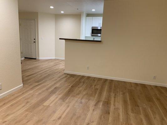 After Remodel: Flooring and Recessed Lighting all throughout the living room to kitchen.