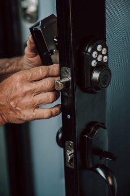 Technician installing an electronic deadbolt