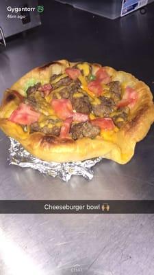 Taco Bowl Supreme salad bowl loaded with ground beef, cheddar cheese, tomatoes, and sour cream