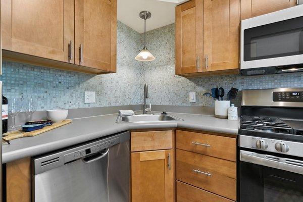 This is our contemporary kitchen style, complete with soft-close cabinetry, glass tile backsplash, and stainless steel appliances.