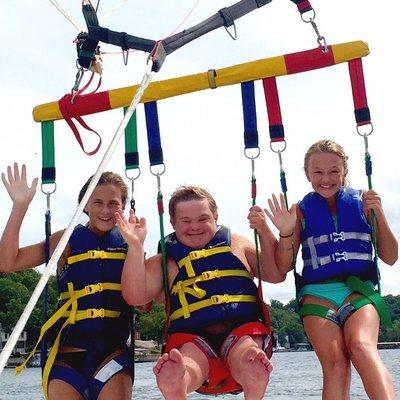 Happy Adventure Seekers taking a parasail flight!