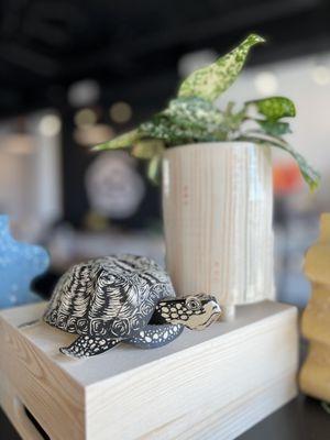 Paper sculpture of a turtle and handcrafted ceramic planter