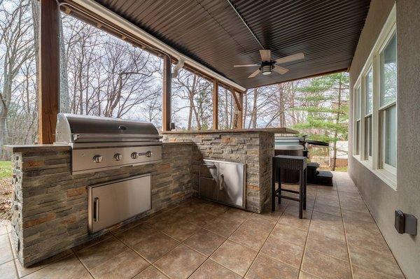 L-shaped Outdoor Kitchen & Raised Bar with a 36" Coyote grill and two single access doors.  (Cornelius, NC).