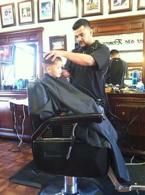 My son getting his hair cleaned up by Jess