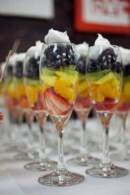 Non traditional fruit display. Fruit and whipped cream in champagne glasses.