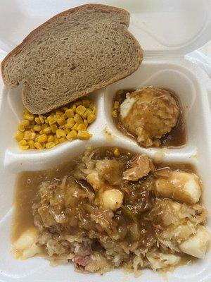 Pork roast, sauerkraut & dumplings, mashed potatoes & gravy with corn and bread.