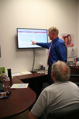 Hearing specialist, Tony, explaining audiogram results to client