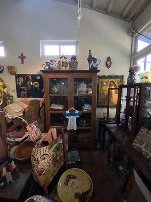 Art work in La Cabana plus a wood cabinet full of authentic talaverra pottery.