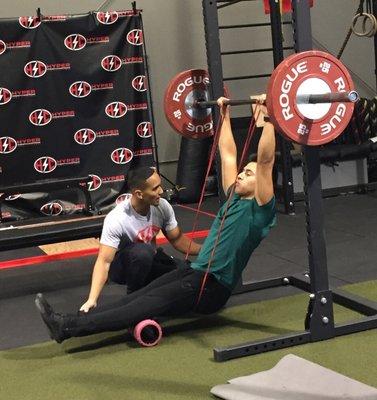 Trainer Alex S. coaching Damon on the progressions to a Muscleup