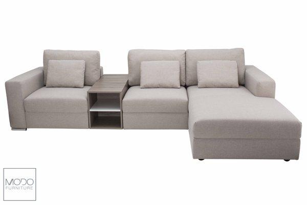 Modular sectional upholstered in natural fabric.