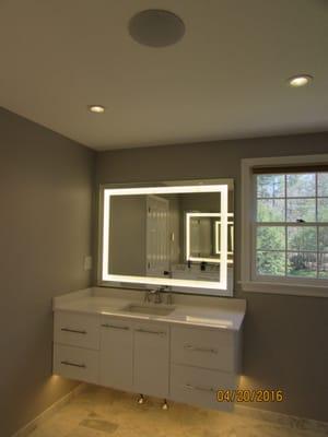 Seura lighted mirror and under cabinet lighting for an extra glow. Speakers installed as well.