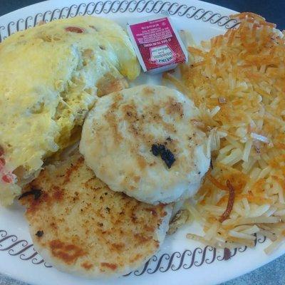 Omelet with tomatoes, cheese, and onions, hash browns, and grilled biscuit. Yum!