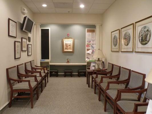 Waiting Room with LCD Flat Screen TV, magazine rack, and play area for kids.