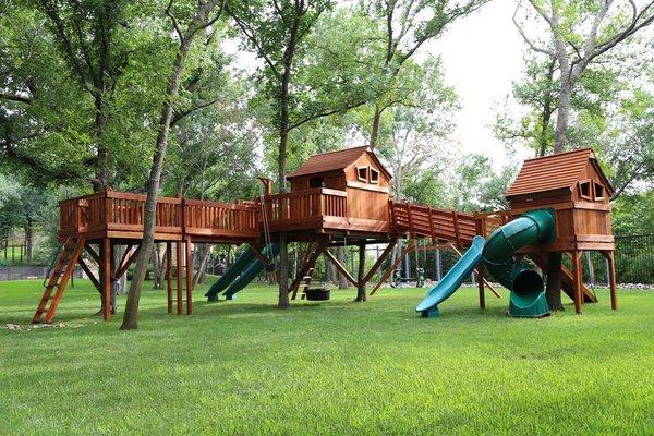 Tree house with angle bridge to Fun Shack. Epic backyard wooden playset.