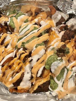 SoCal Asada fries: curly fries, cheese, sour cream, guacamole, cilantro, grilled onions, grilled jalapeno, and sauce. $16.95.