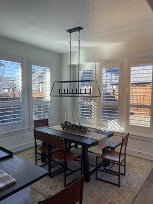 Breakfast nook with 4 inch hidden tilt white polycore plantation shutters with limited lifetime warranty.