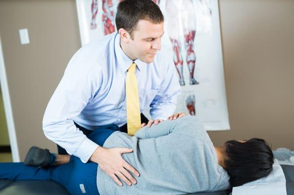 Dr. James adjusts a patient's low back.