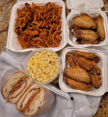 Breaded chicken cutlet hero, curly fries, macaroni & cheese and traditional wings